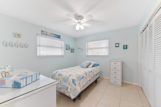 522 Evergreen Dr, Lake Park, FL 33403 - bedroom featuring a closet, light tile patterned floors, a ceiling fan, and baseboards