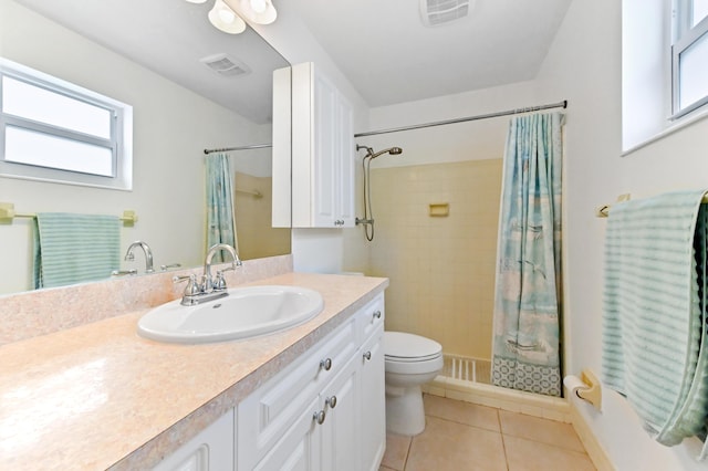 522 Evergreen Dr, Lake Park, FL 33403 - bathroom featuring tile patterned floors, vanity, toilet, tiled shower, and plenty of natural light