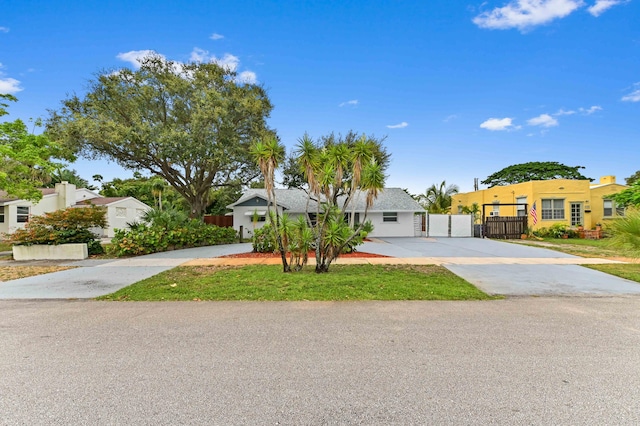 522 Evergreen Dr, Lake Park, FL 33403 - view of front of home with driveway, a gate, and a residential view