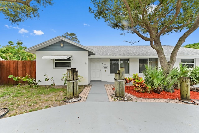 522 Evergreen Dr, Lake Park, FL 33403 - view of front of property featuring a shingled roof and stucco siding