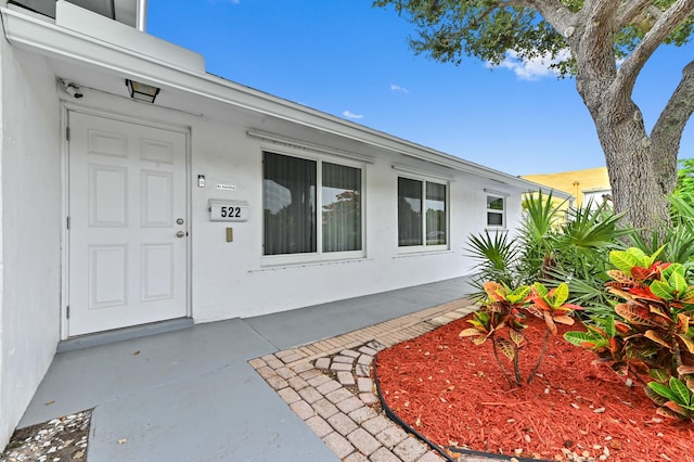 522 Evergreen Dr, Lake Park, FL 33403 - doorway to property featuring stucco siding