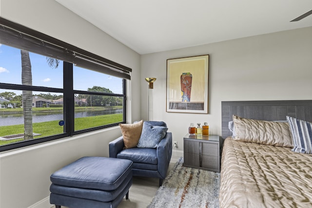 12829 Briarlake Dr Unit 102, Palm Beach Gardens, FL 33418 - bedroom with baseboards, a water view, and wood finished floors