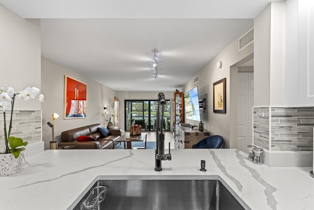 12829 Briarlake Dr Unit 102, Palm Beach Gardens, FL 33418 - kitchen featuring open floor plan, light stone countertops, and decorative backsplash