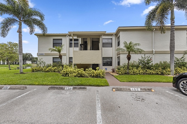 12829 Briarlake Dr Unit 102, Palm Beach Gardens, FL 33418 - view of building exterior featuring uncovered parking