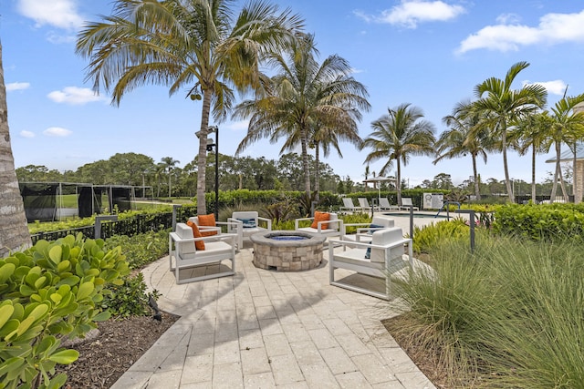 12829 Briarlake Dr Unit 102, Palm Beach Gardens, FL 33418 - view of patio featuring a swimming pool and a fire pit