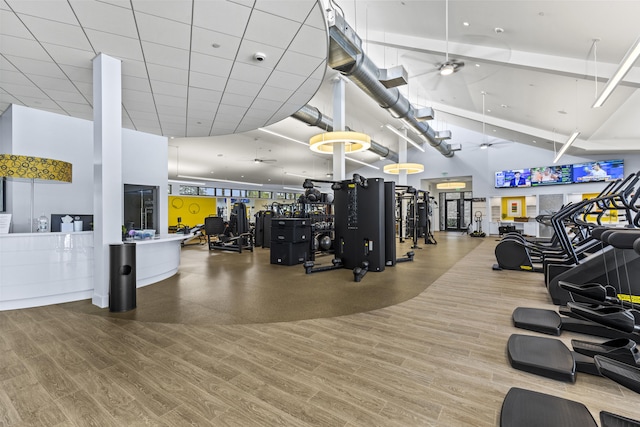 12829 Briarlake Dr Unit 102, Palm Beach Gardens, FL 33418 - workout area featuring a ceiling fan, a towering ceiling, and wood finished floors