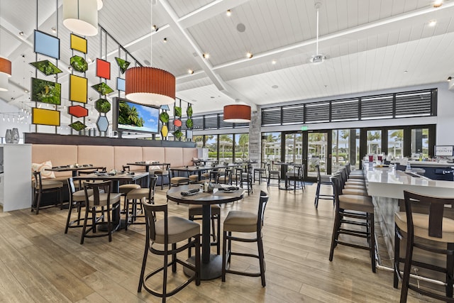 12829 Briarlake Dr Unit 102, Palm Beach Gardens, FL 33418 - dining space with high vaulted ceiling, wood finished floors, healthy amount of natural light, and wooden ceiling with exposed beams