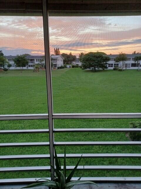 127 Berkshire F, West Palm Beach, FL 33417 - yard at dusk with a lawn