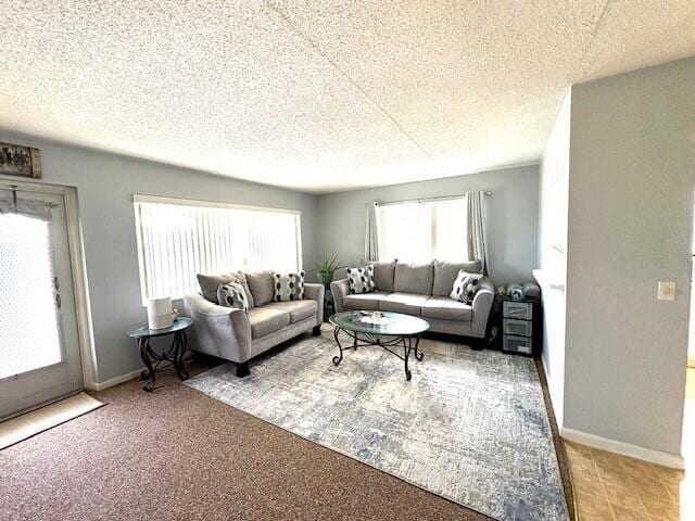 127 Berkshire F, West Palm Beach, FL 33417 - living area featuring a textured ceiling and baseboards