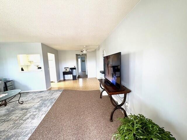 127 Berkshire F, West Palm Beach, FL 33417 - carpeted living room with a ceiling fan, a textured ceiling, and baseboards