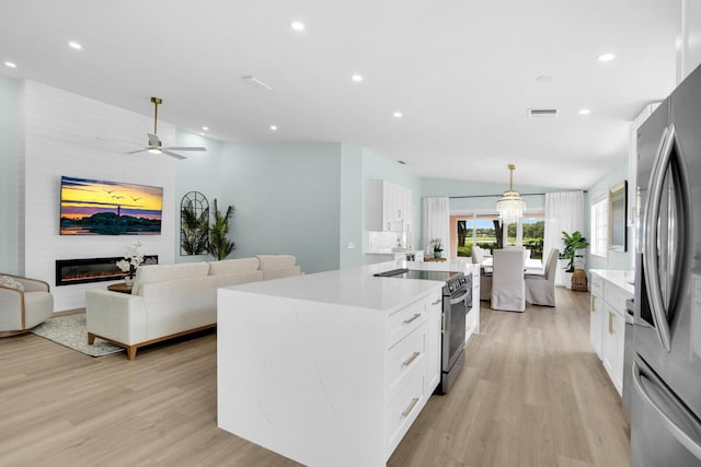 889 SW Balmoral Trce, Stuart, FL 34997 - kitchen with stainless steel appliances, light wood-style flooring, white cabinets, light countertops, and recessed lighting