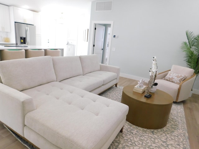889 SW Balmoral Trce, Stuart, FL 34997 - living area featuring light wood-style floors and baseboards