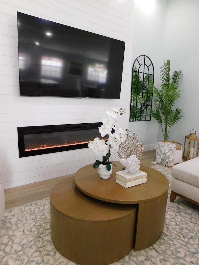 889 SW Balmoral Trce, Stuart, FL 34997 - living area with a glass covered fireplace and wood finished floors