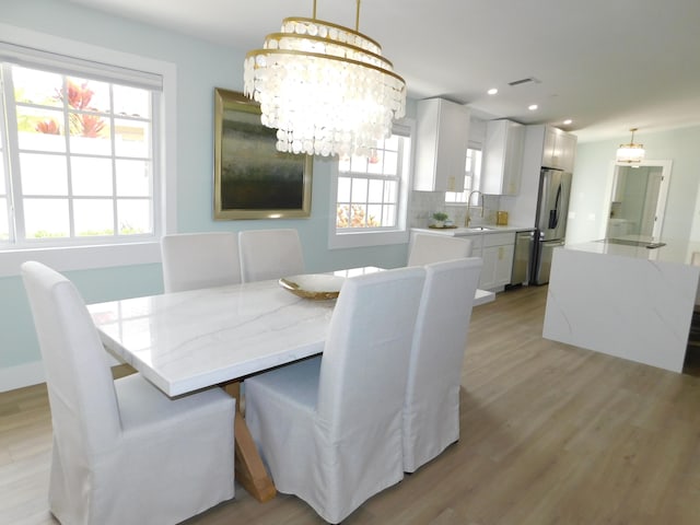 889 SW Balmoral Trce, Stuart, FL 34997 - dining space featuring a chandelier, light wood finished floors, and recessed lighting