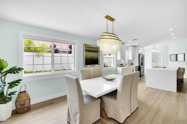 889 SW Balmoral Trce, Stuart, FL 34997 - dining area with light wood-style flooring, a chandelier, healthy amount of natural light, baseboards, and recessed lighting