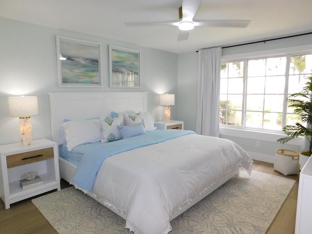 889 SW Balmoral Trce, Stuart, FL 34997 - bedroom with multiple windows, wood finished floors, and ceiling fan