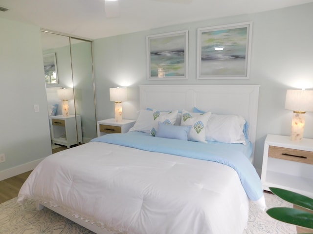 889 SW Balmoral Trce, Stuart, FL 34997 - bedroom featuring wood finished floors and a closet