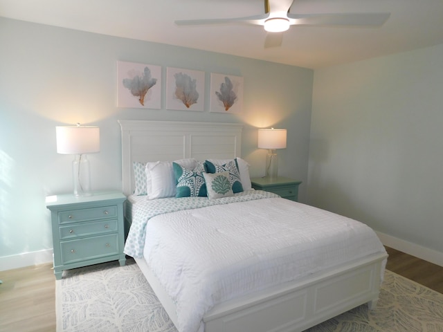 889 SW Balmoral Trce, Stuart, FL 34997 - bedroom with light wood finished floors, baseboards, and a ceiling fan