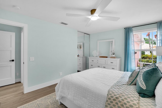 889 SW Balmoral Trce, Stuart, FL 34997 - bedroom featuring light wood-style floors, baseboards, and a ceiling fan