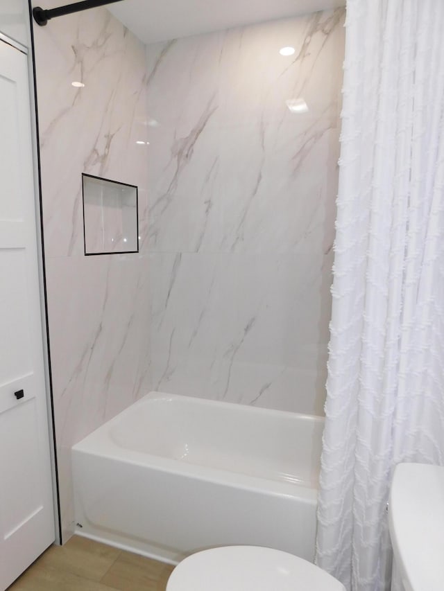 889 SW Balmoral Trce, Stuart, FL 34997 - full bathroom featuring toilet, shower / bath combo with shower curtain, and wood finished floors