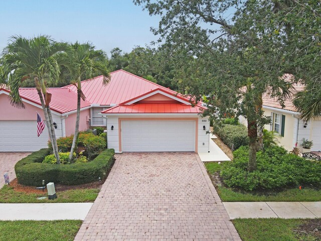 889 SW Balmoral Trce, Stuart, FL 34997 - ranch-style house with a front yard and metal roof