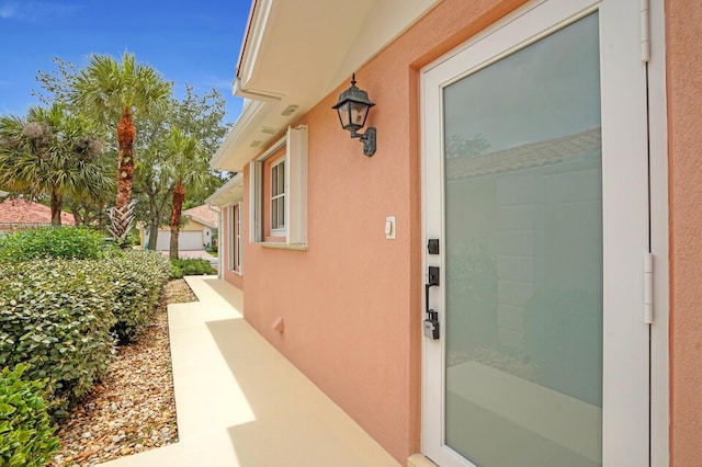 889 SW Balmoral Trce, Stuart, FL 34997 - view of exterior entry featuring stucco siding