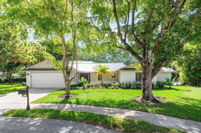 3356 NW 24th Way, Boca Raton, FL 33431 - ranch-style home with a garage, concrete driveway, a metal roof, and a front yard