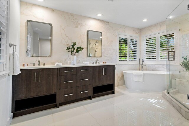 3356 NW 24th Way, Boca Raton, FL 33431 - bathroom featuring double vanity, a freestanding bath, a stall shower, tile walls, and tile patterned floors