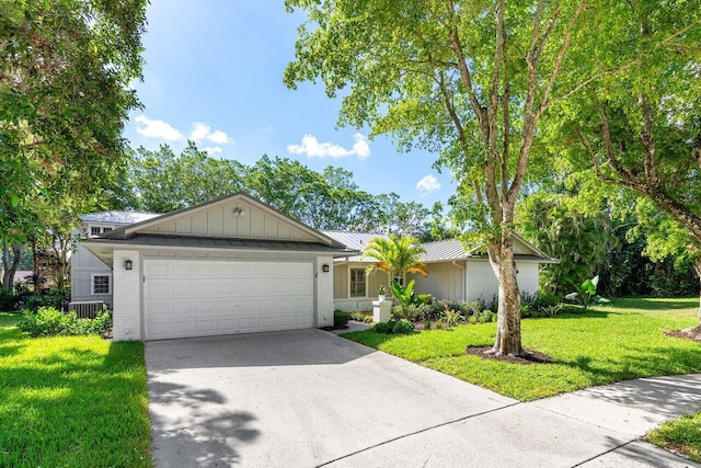 3356 NW 24th Way, Boca Raton, FL 33431 - ranch-style house featuring board and batten siding, an attached garage, a front yard, driveway, and brick siding
