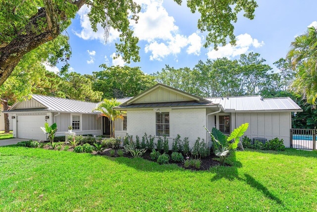 3356 NW 24th Way, Boca Raton, FL 33431 - single story home featuring board and batten siding, a metal roof, driveway, and brick siding