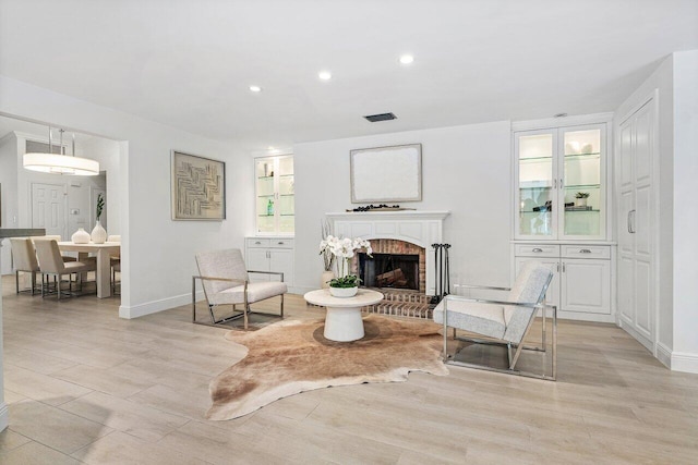 3356 NW 24th Way, Boca Raton, FL 33431 - living room featuring a fireplace, light wood-style floors, and recessed lighting