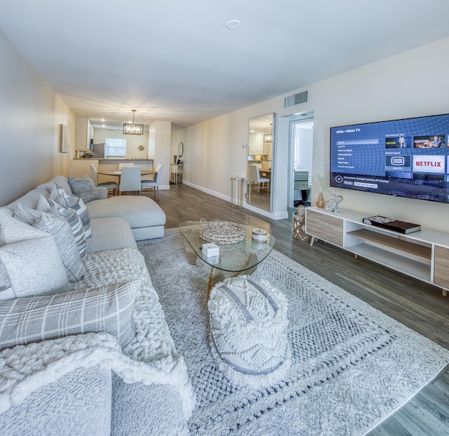 1428 S Lakeside Dr Unit 31, Lake Worth Beach, FL 33460 - living room with a chandelier, wood finished floors, and baseboards