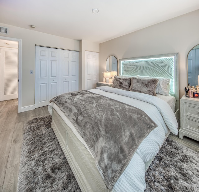 1428 S Lakeside Dr Unit 31, Lake Worth Beach, FL 33460 - bedroom featuring light wood-style floors, multiple closets, and baseboards