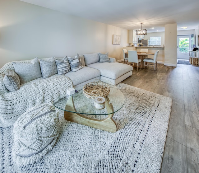 1428 S Lakeside Dr Unit 31, Lake Worth Beach, FL 33460 - living room featuring hardwood / wood-style floors, a chandelier, and baseboards