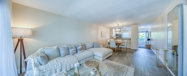 1428 S Lakeside Dr Unit 31, Lake Worth Beach, FL 33460 - living area with wood finished floors, baseboards, and a chandelier