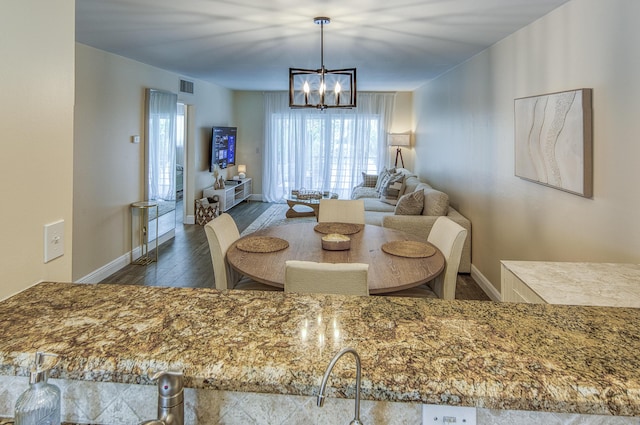 1428 S Lakeside Dr Unit 31, Lake Worth Beach, FL 33460 - dining area with wood finished floors, a chandelier, and baseboards