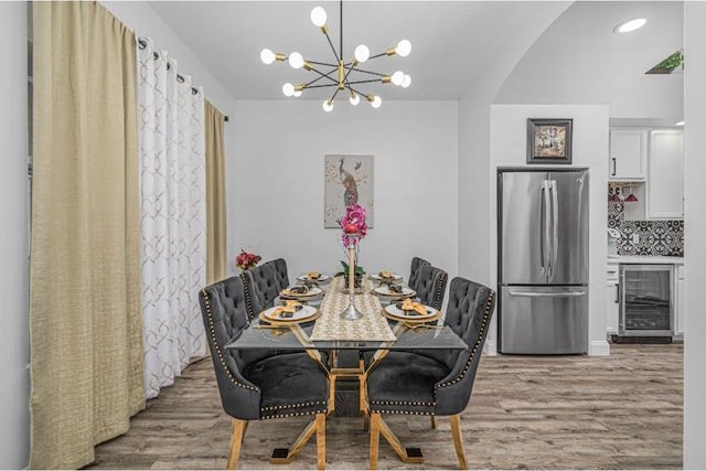 1583 SW Harbour Isles Cir Unit 57, Port Saint Lucie, FL 34986 - dining space featuring beverage cooler, light wood finished floors, a chandelier, and arched walkways
