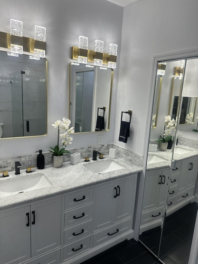 1583 SW Harbour Isles Cir Unit 57, Port Saint Lucie, FL 34986 - full bathroom featuring tile patterned flooring, double vanity, a stall shower, and decorative backsplash