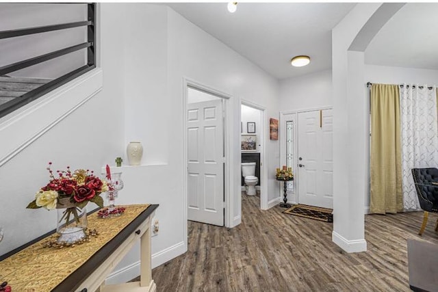 1583 SW Harbour Isles Cir Unit 57, Port Saint Lucie, FL 34986 - entryway with arched walkways, baseboards, and dark wood-style flooring