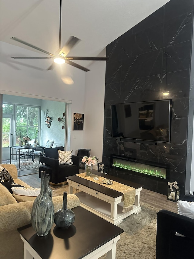 1583 SW Harbour Isles Cir Unit 57, Port Saint Lucie, FL 34986 - living area with a ceiling fan, vaulted ceiling, wood finished floors, and a fireplace