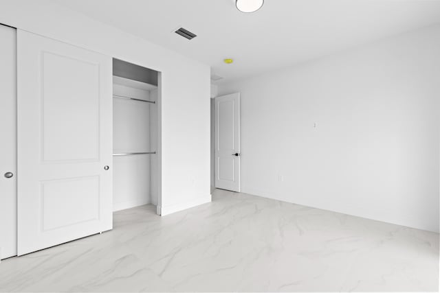 4037 SW Port St Lucie Blvd, Port Saint Lucie, FL 34953 - unfurnished bedroom with light marble finish floors, a closet, and baseboards