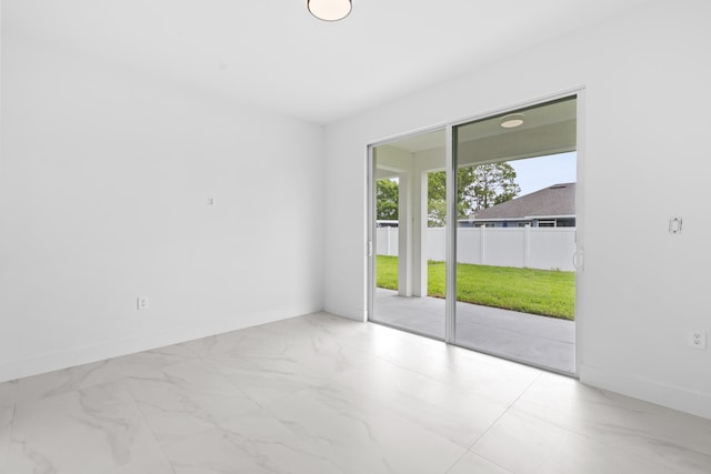 4037 SW Port St Lucie Blvd, Port Saint Lucie, FL 34953 - empty room featuring marble look tile flooring and baseboards