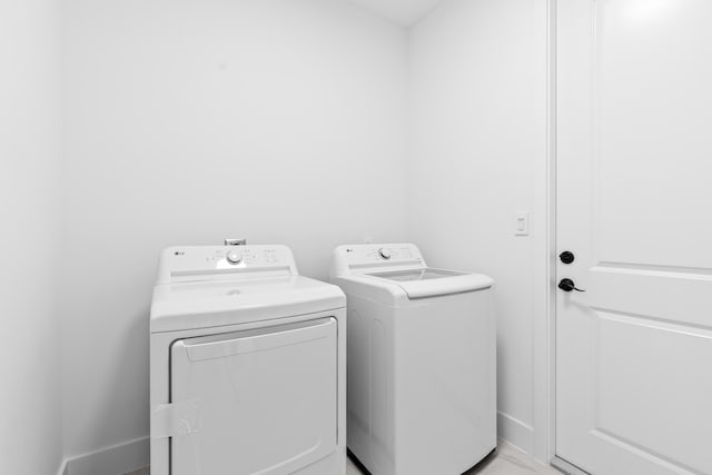 4037 SW Port St Lucie Blvd, Port Saint Lucie, FL 34953 - washroom featuring washing machine and dryer and baseboards