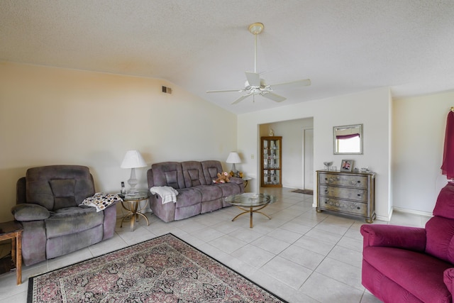 858 SE Roulette Ln, Port Saint Lucie, FL 34983 - living area featuring a ceiling fan, light tile patterned floors, lofted ceiling, and a textured ceiling