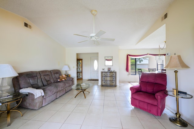 858 SE Roulette Ln, Port Saint Lucie, FL 34983 - living area with vaulted ceiling, a ceiling fan, light tile patterned floors, and a textured ceiling