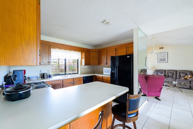 858 SE Roulette Ln, Port Saint Lucie, FL 34983 - kitchen featuring light countertops, a peninsula, open floor plan, light tile patterned floors, and a sink