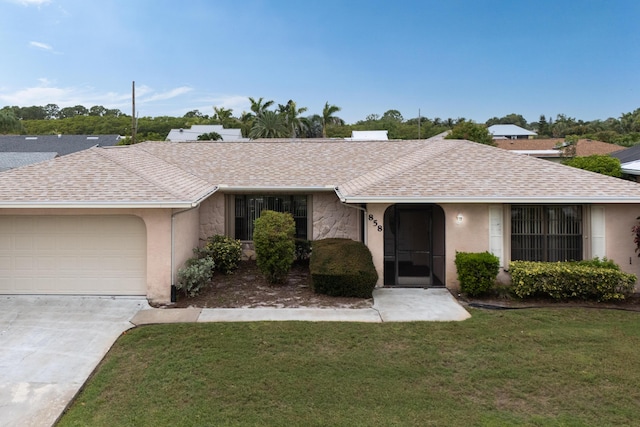 858 SE Roulette Ln, Port Saint Lucie, FL 34983 - ranch-style home featuring a front lawn, an attached garage, concrete driveway, stone siding, and a shingled roof
