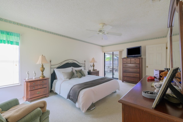 858 SE Roulette Ln, Port Saint Lucie, FL 34983 - bedroom featuring access to outside, a textured ceiling, light carpet, and ceiling fan
