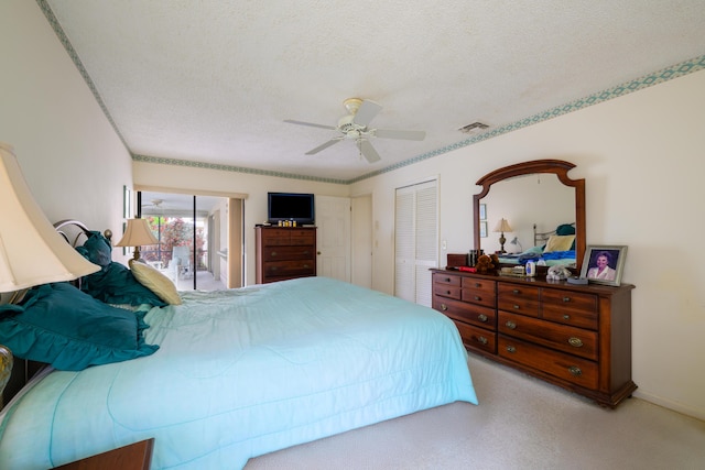858 SE Roulette Ln, Port Saint Lucie, FL 34983 - carpeted bedroom with a closet, a textured ceiling, and ceiling fan
