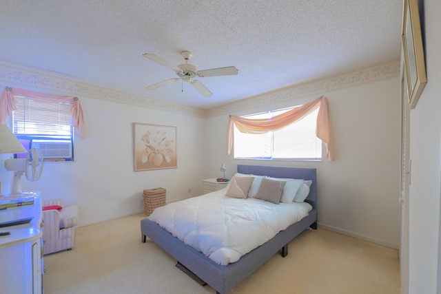 858 SE Roulette Ln, Port Saint Lucie, FL 34983 - bedroom featuring multiple windows, carpet flooring, a ceiling fan, and a textured ceiling